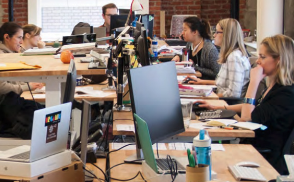 Ein Team kreativer Mitarbeiter arbeitet an Computern.
