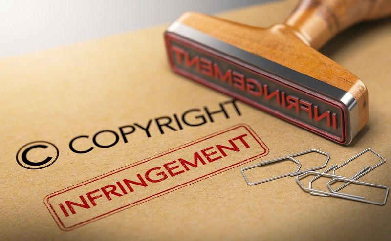 Ein Gummistempel mit dem Wort 'Verletzung' für das Bildcopyright.
