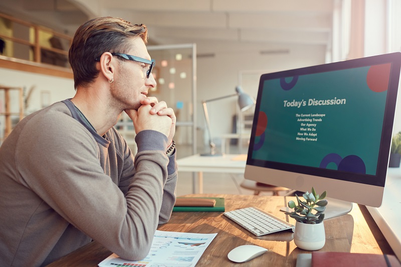 A man working on a digital presentation.